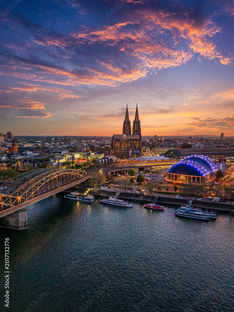Fototapeta premium Aerial view of the skyline of Cologne, Germany, with river Rhine and famous Cathedral during twilight