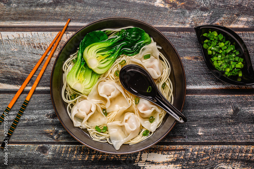 Noodle soup with dumplings (wontons) and cabbage bok choy