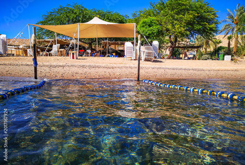 Beautiful resting beach in Eilat. Safety swimming area at public comfortable ...