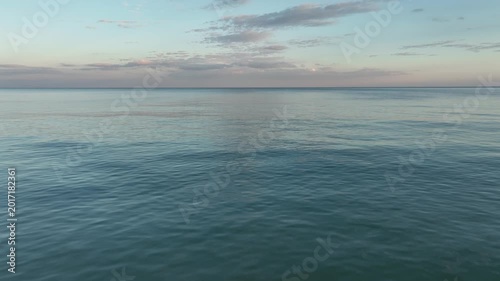 Video flight over ocean, sea on sunrise. Close to the water