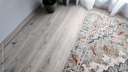 Natural wood laminate parquet floor. Room with floating laminate in new apartmen. Cozy home interior, modern design