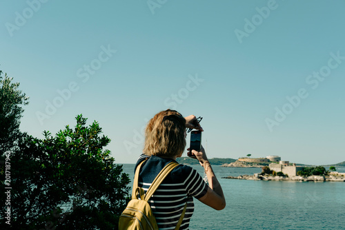 woman traveller and outdoor explorer taking photo of Miriste and Mamula islands in Montenegro