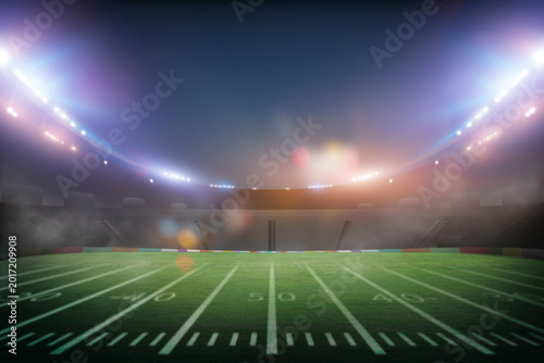 green field in american football stadium with copy space on dark background