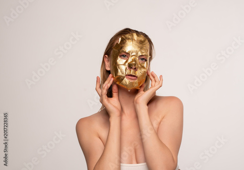 Konstfotografi Woman applying gold leaf facial mask for luxury skincare beauty treatment, anti-