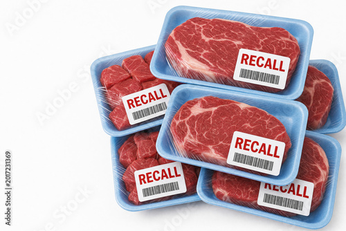 Assorted raw beef steaks in blue foam trays with recall labels