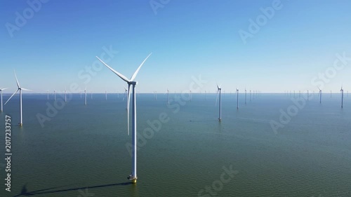 Wind turbines produce energy in the North Sea, wind farm power plant view from height, green energy, alternative energy sources.
