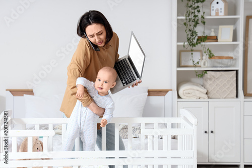 Young mother multitasking w...