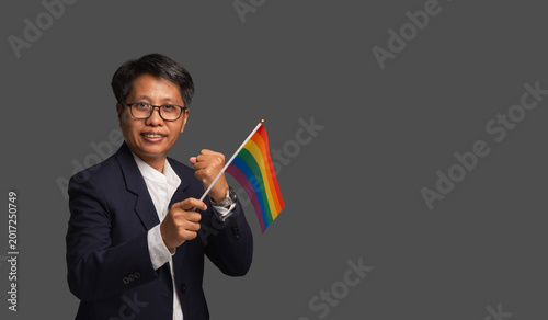 Business woman holding rainbow flag for diversity support