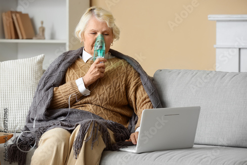 Senior woman with laptop us...
