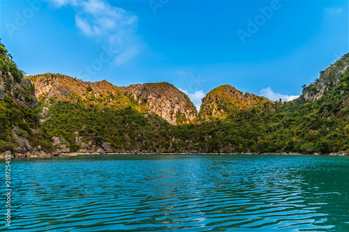 Fotografija A view from a sampan in an internal bay accessed from a water eroded tunnel thro
