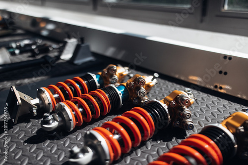 Close-up of racing car suspension shock absorber in motorsport garage