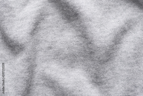 Close-up texture of grey cotton-modal blend fabric. Smooth, soft, and high-quality textile material with a fine weave. Ideal for fashion, apparel background, or garment industry concepts.