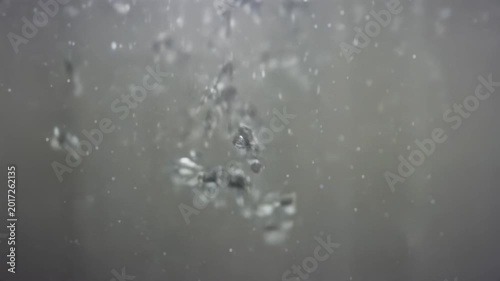 Bubbles rising through clear water, showcasing the continuous movement and interaction of air and liquid in a serene underwater environment