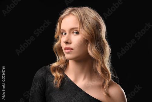 Blonde young woman with cur...