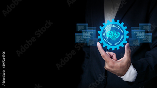 Digital Innovation in Action: A well-dressed individual delicately holds a glowing digital gear, symbolizing the power of technological innovation and its transformative impact.
