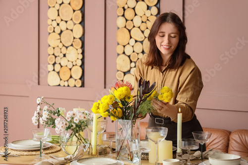Young happy woman serving t...