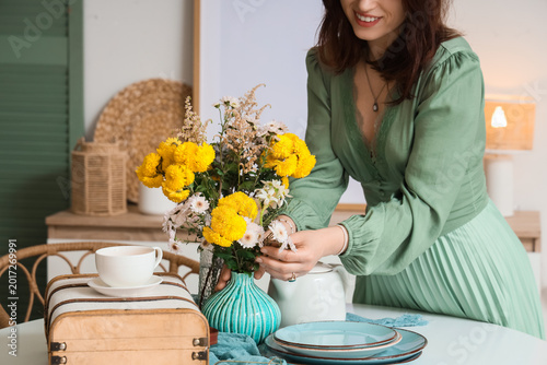 Young happy woman serving t...