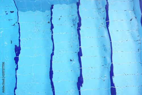 Blue pool filled with water in Summer