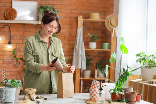 Young woman taking plant po...