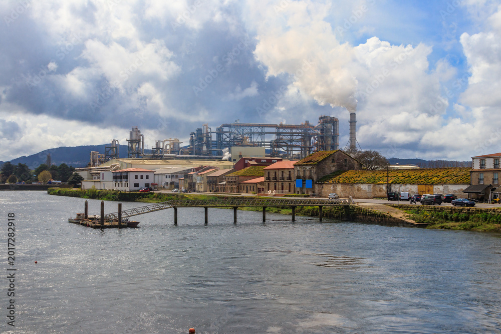 Fototapeta premium Industrial landscape. View of factory on the bank of the Ulla River in Padron, Spain