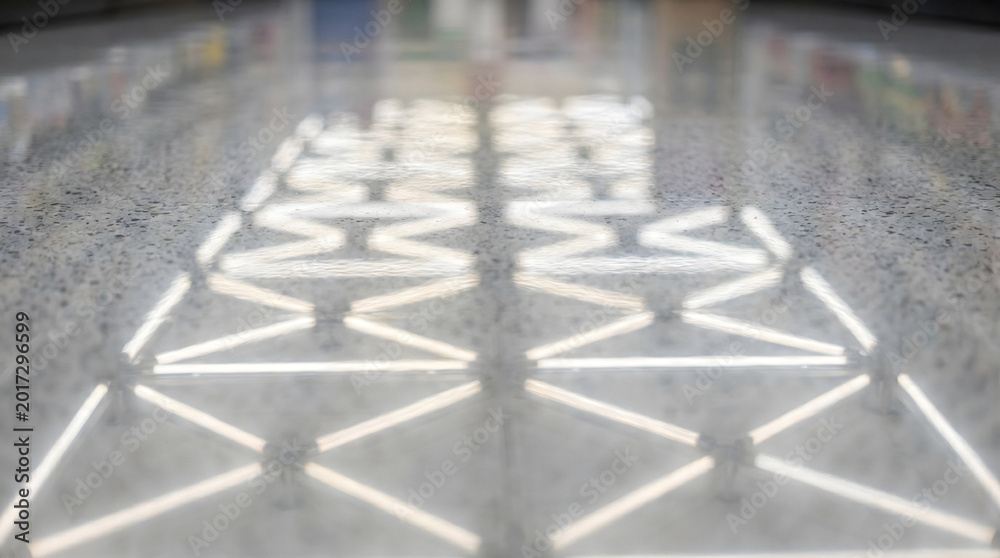 Fototapeta premium modern fluorescent light grid reflection on wet floor minimalist design