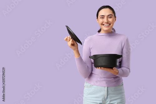 Young woman holding cooking...