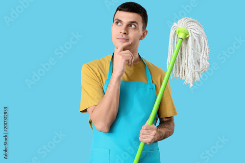 Thoughtful male janitor wit...