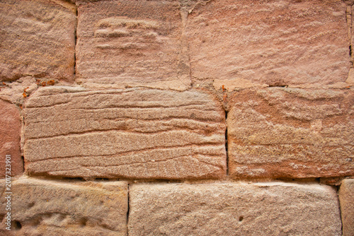 texture of a red sandstone wall with natural horizontal sedimentary patterns and rough blocks, Nurnberg