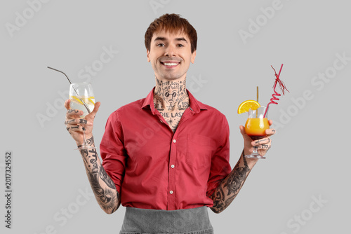 Young male bartender with g...