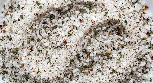 Fotografija Coarse sea salt mixed with dried herbs and chili flakes creating a flavorful sea