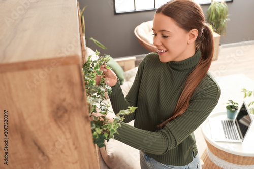 Young woman with plant on s...