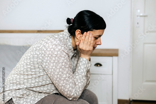 Foto Depressed mature woman experiencing menopause or perimenopause