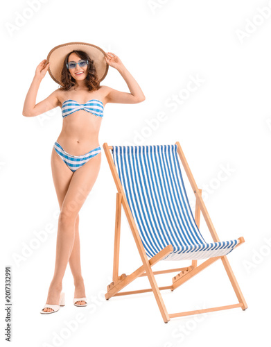 Young woman with deck chair...