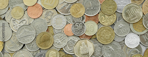 Scattered coins of multiple origins in big mound, detailed shot. World currency variety