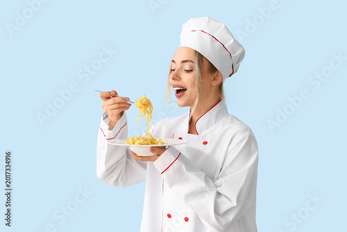 Female chef eating tasty pa...