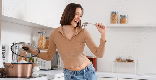 Young woman with ladle and ...