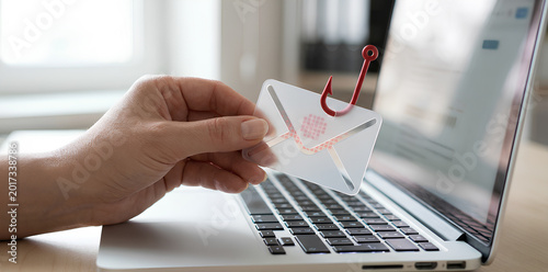Obraz na plátně Phishing scam via email man becomes a victim after receiving spoofed and fraudulent messages on his laptop