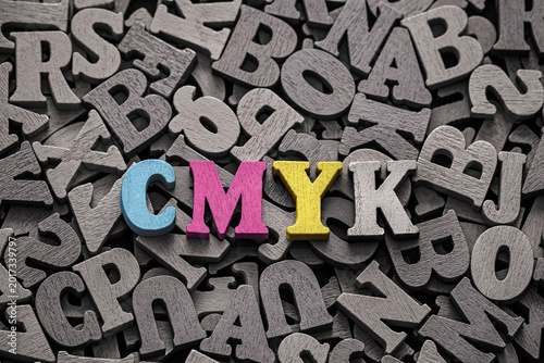 Tableau sur toile Inscription cmyk on pile of old vintage wooden letters.