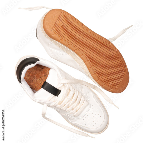 stylish white female sneakers with laces isolated on a white background