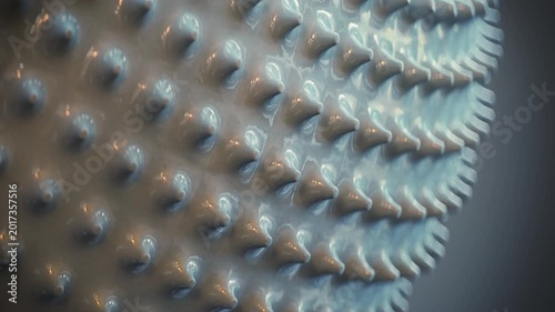 Seamless loop animation of a rotating glossy geometric surface with repeating spikes. Futuristic abstract motion background with soft cinematic lighting and minimal design. 3D render