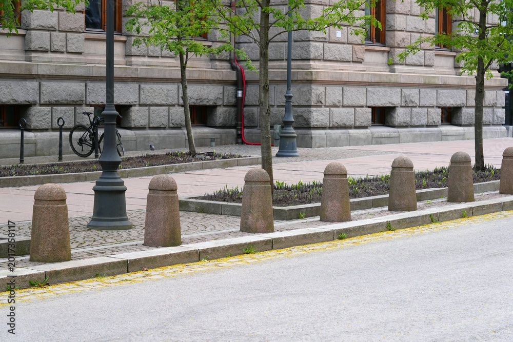 Fototapeta premium Traffic bollards made of stone to prevent cars parking on pedestrian sidewalk. Municipal transportation infrastructure in Oslo, Norway.