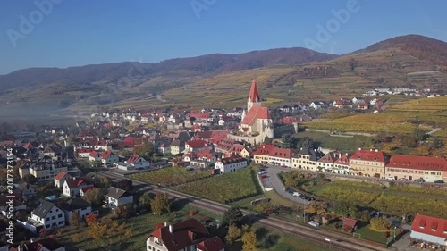 Aerial panorama of Weisenkirchen in der Wachau town and vineyards at autumn morning with fog over Danube river. Wachau valley, Austria. 2.5x speeded up from 24 fps.