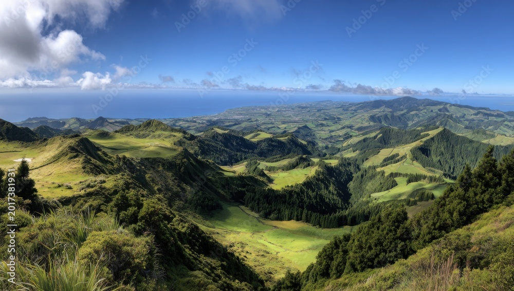 Fototapeta premium Panoramic View of Lush Green Volcanic Landscape with Rolling Hills and Ocean Horizon.