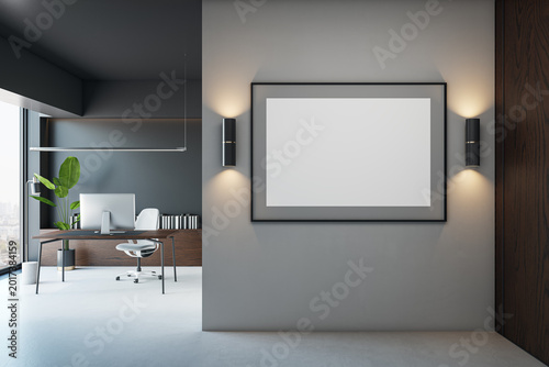 Modern corporate office interior featuring a large blank frame on a clean wal...