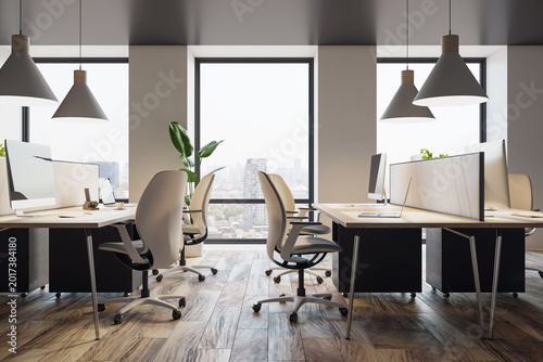 Modern open-plan corporate office interior with desks, chairs, computers, lar...