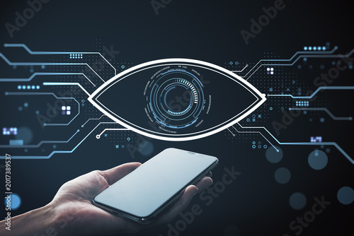 Smartphone in hand with futuristic digital eye interface and circuit elements...