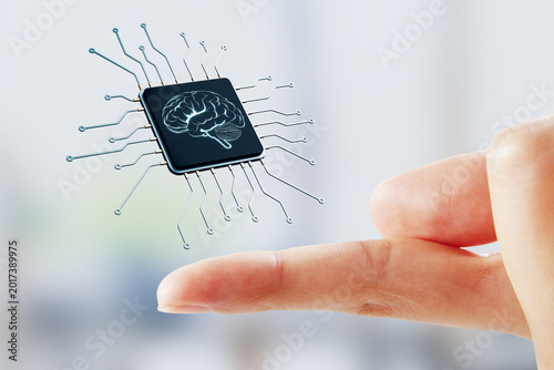 Human finger pointing toward floating microchip with glowing brain icon repre...