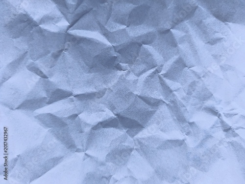 Crushed blue paper texture with dramatic shadows and highlights for abstract backgrounds