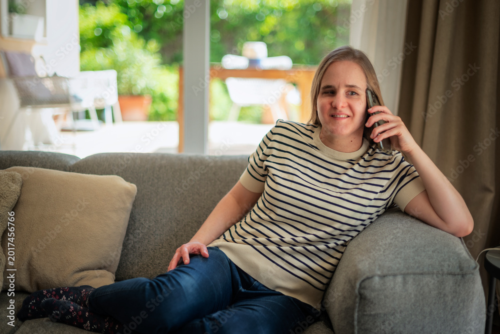 Fototapeta premium A visually impaired woman using her smartphone at home