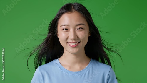 Woman in Green Environment with Bright Smile and Long Hair